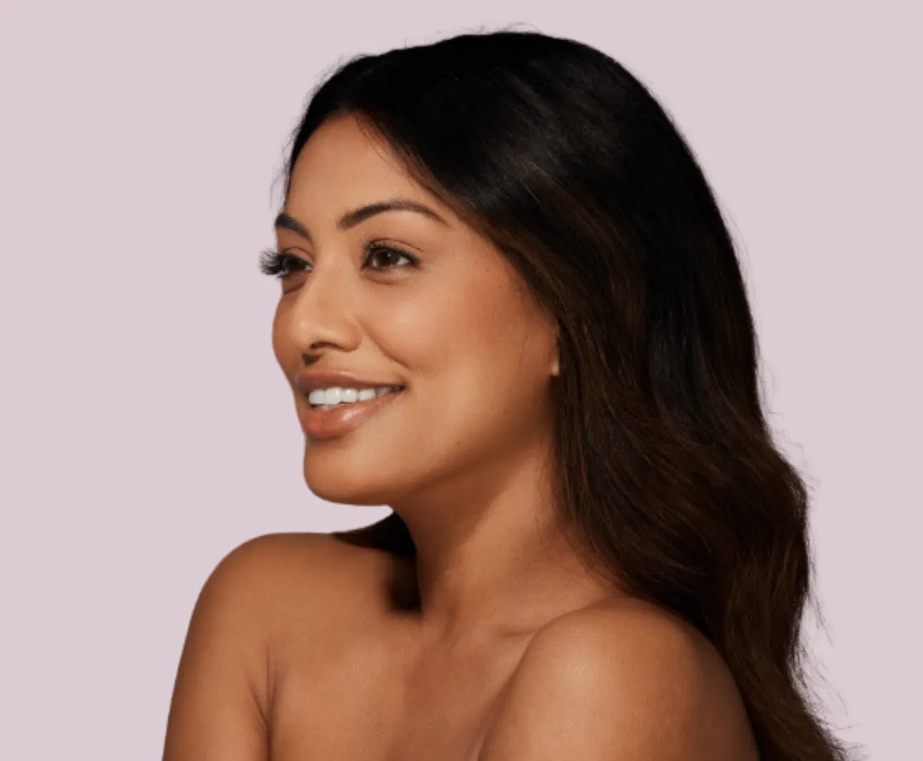 Skinvive_Website Slim tanned woman's body over gray background