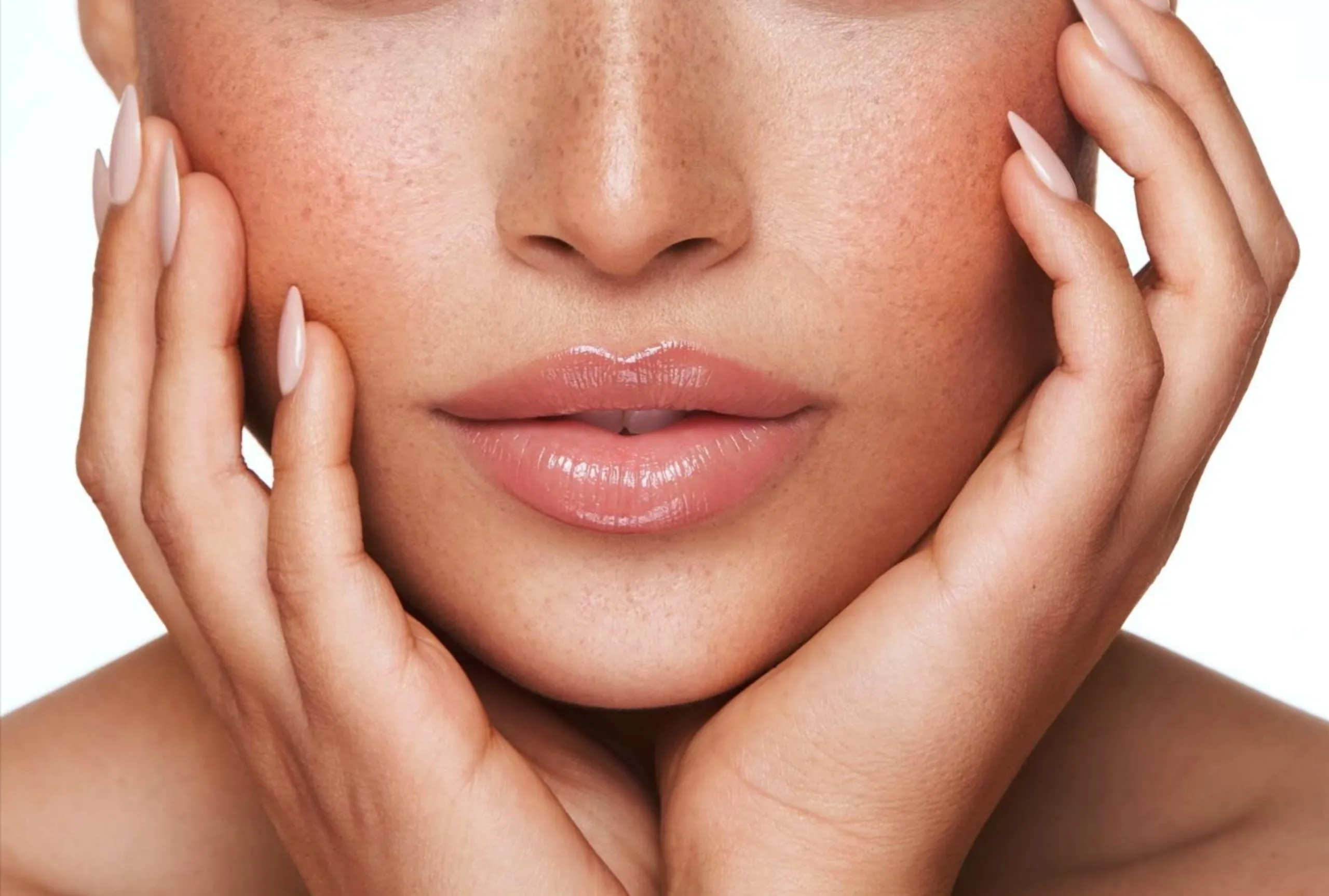 Close-up of a woman's radiant face and clear skin after laser treatment at Greenwich Medical Spa, emphasizing proper aftercare and protection from sun exposure following facial laser hair removal.