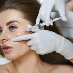 Woman receiving facial filler treatment at Greenwich Medical Spa, highlighting natural filler results and techniques to avoid an overfilled filler face or bad fillers.